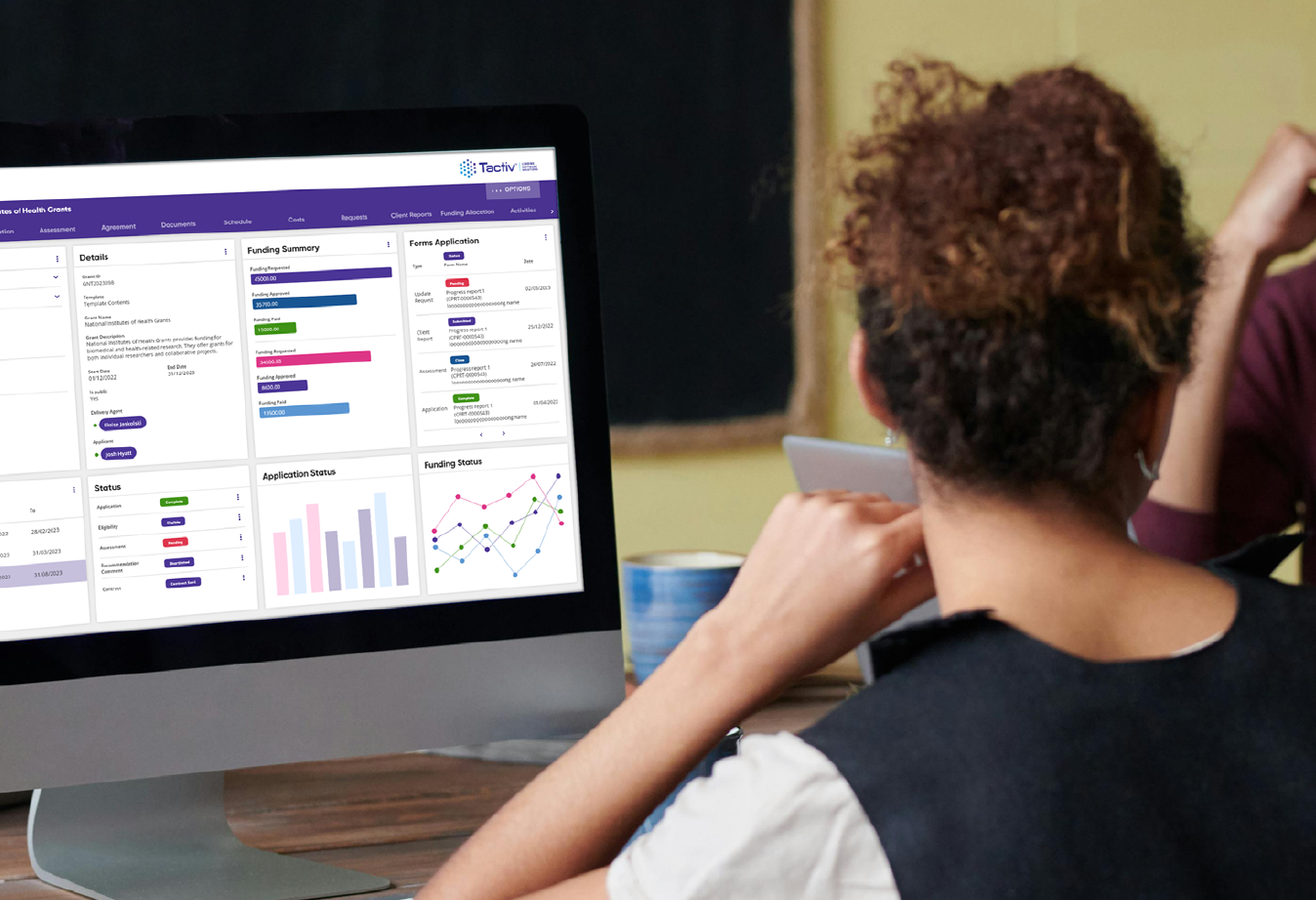 Person behind screen with Enquire scholarship management solution open