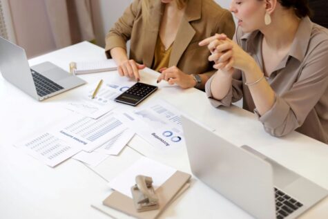Grant reporting team with papers on table