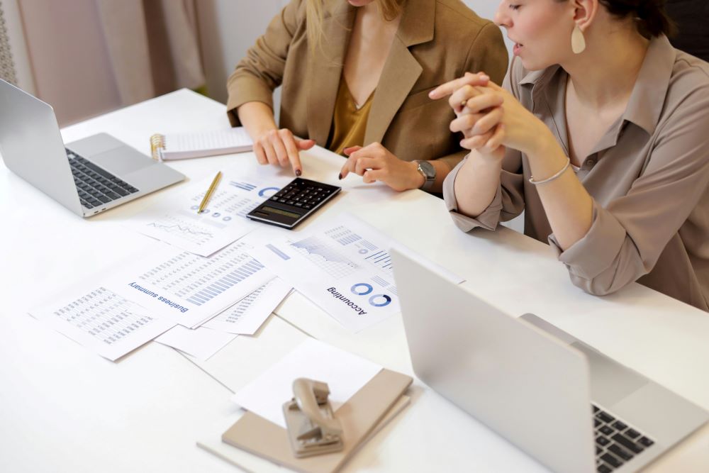 Grant reporting team with papers on table